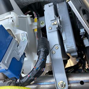 Upper brackets connecting HV ECU (right) to ECM (left), and ECM to chassis.